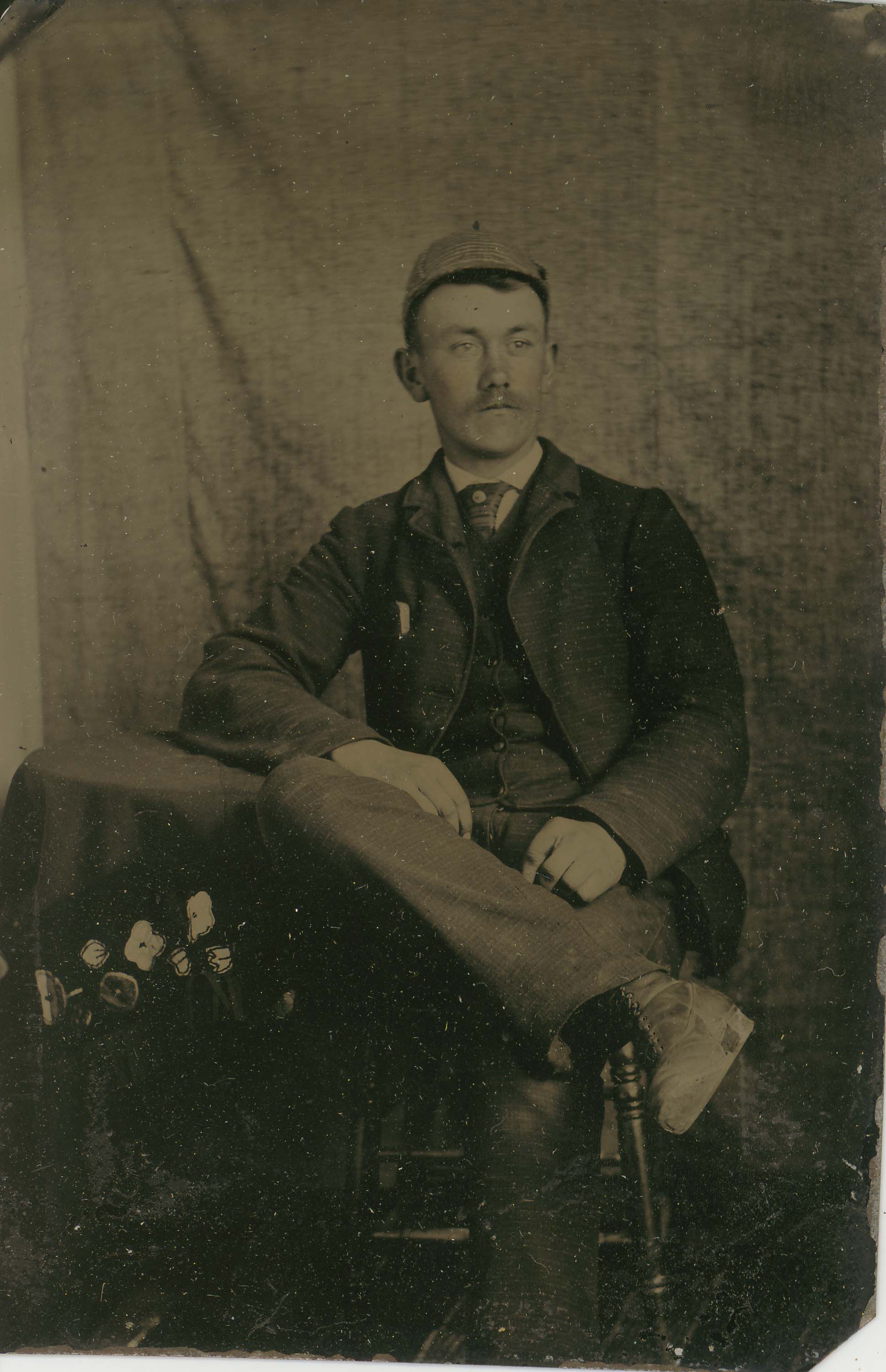 Tin-type-1-Man-seated-at-table-with-cap