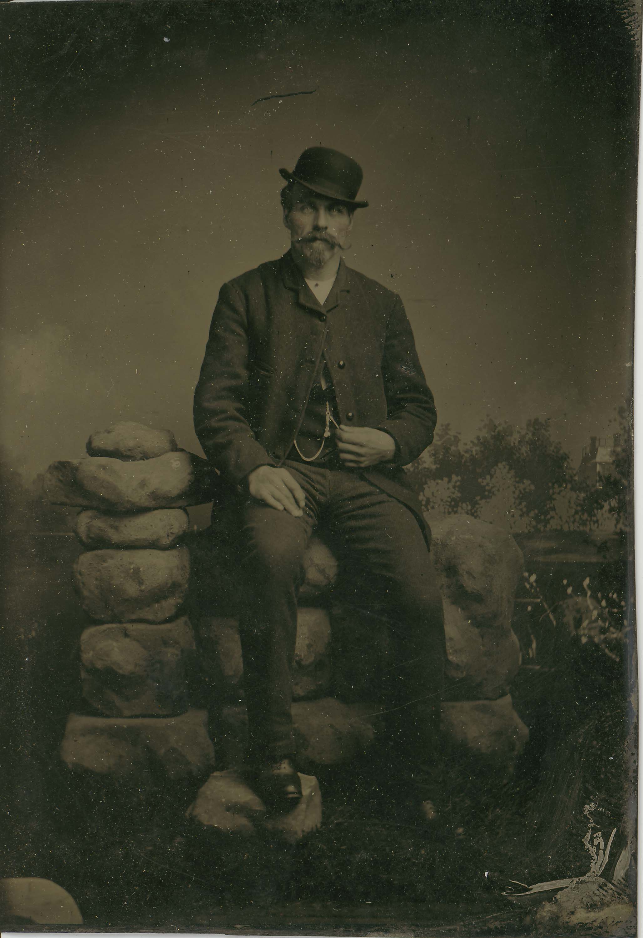 Tin-type-4-Man-seated-on-rock-Wall